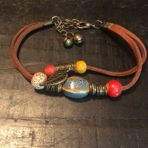 NWT Faux leather brown cord & bead bracelet w/feather charm. 7” with 2” extender